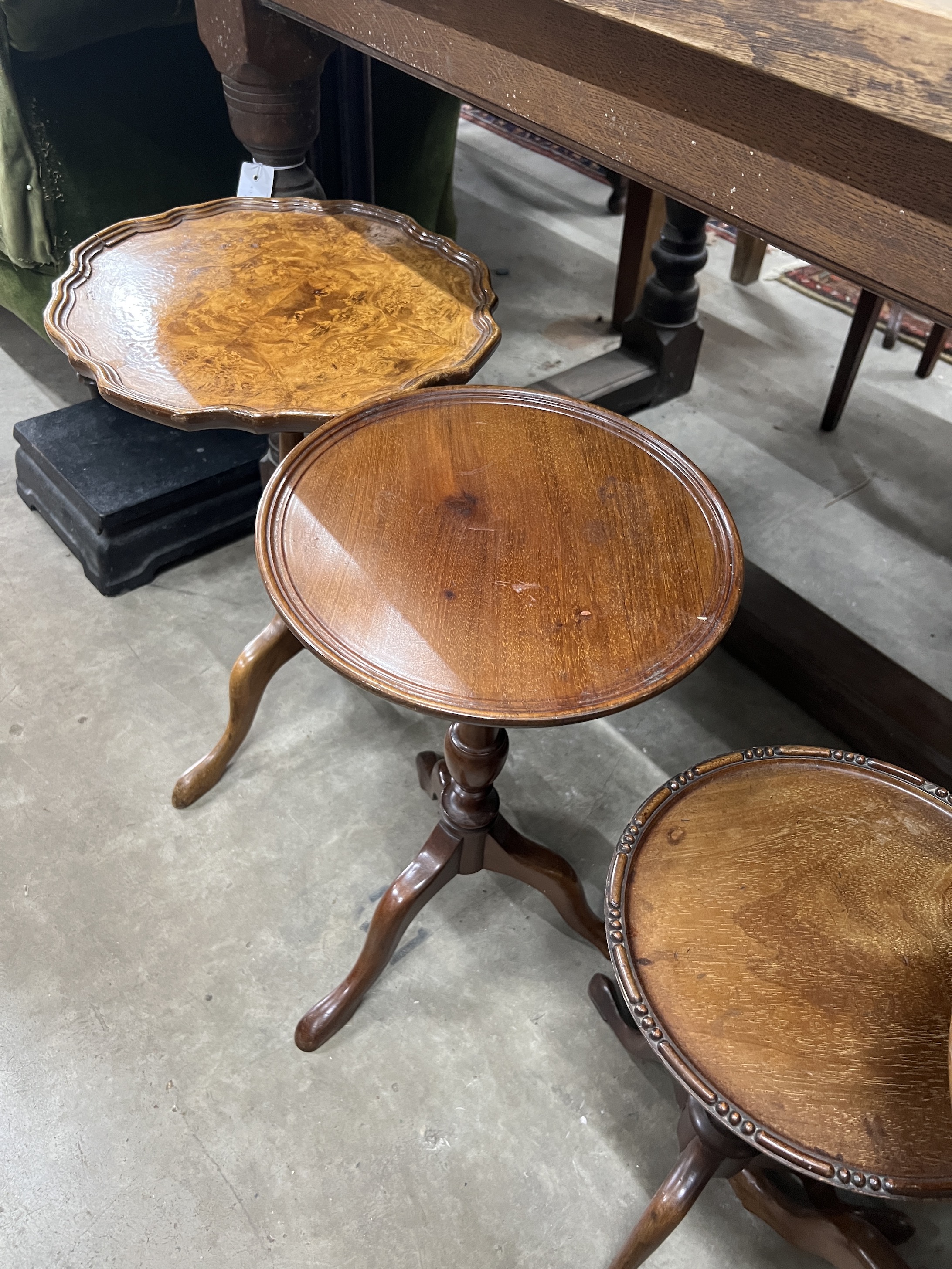 Five early 20th century and later circular mahogany and walnut tripod wine tables, largest diameter 37cm, height 63cm